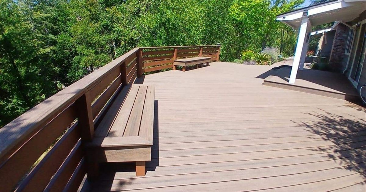 Brown composite decking with built-in bench on a Portland deck, weighing composite decking pros and cons in person