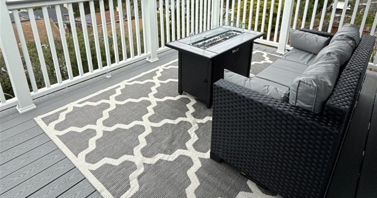 Gray PVC deck with white railing on an elevated Portland site, where the PVC vs composite decking choice tips toward PVC